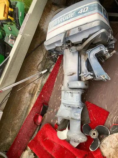 40hp Evinrude outboard motor with optional boat. Transom is rotten on boat. All controls for motor a...