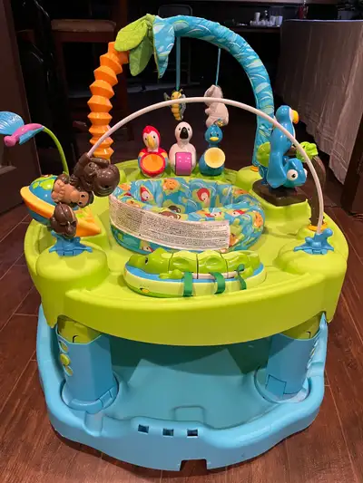 Eve Flo Exersaucer Activity Centre adjustable height includes, mobiles light and sound generating pl...
