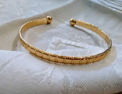 Ladies Vintage Bangle Bracelet Gold tone Plating with texture on top It's flexible so it's easy on &...