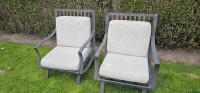 Two outdoor chairs with cushions. 