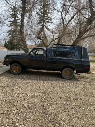 Two 1970 GMC 1/2 tons for sale Orange 2 WD 6 cylinder standard with new front fenders Black 4 WD V8...
