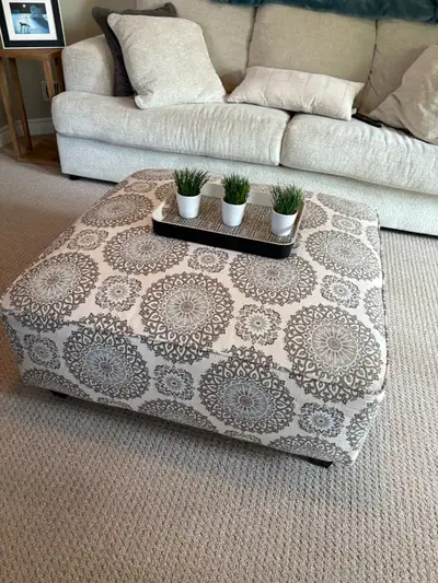 This stylish ottoman features a beautiful, intricate pattern in neutral tones, making it a versatile...