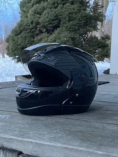 This is a black motorcycle helmet, perfect for ensuring safety on the road. It is in used condition....