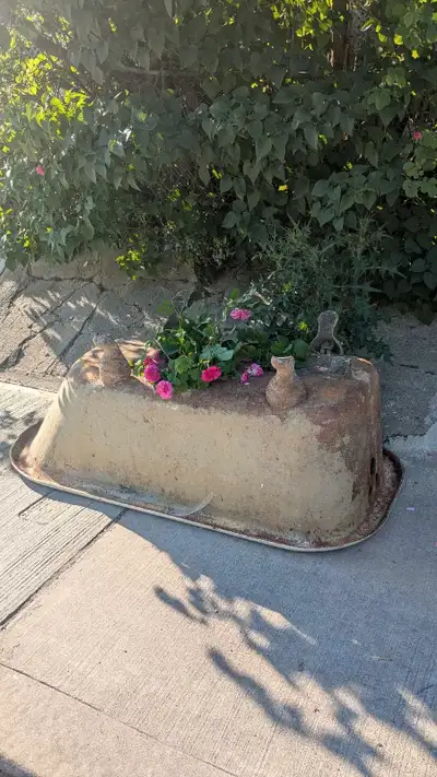 Freem heavy netsl tub on the curb ready for pickup.