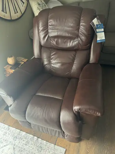 Near new high quality brown leather (real leather) power reclining lounge chair. USB charging port o...