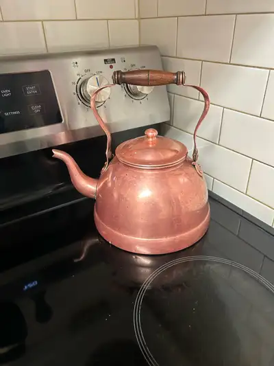 This is a delightful copper tea kettle, perfect for adding a touch of vintage charm to your kitchen!...