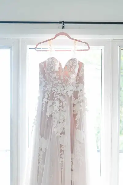 Minor alterations to shorten it a bit and we took it in about 3 inches! Worn for my wedding in Septe...