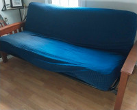 Futon with gray mattress and blue slip cover