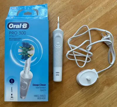 Oral-B Pro 300 Vitality rechargeable toothbrush. Slightly used. Requires new brush head.