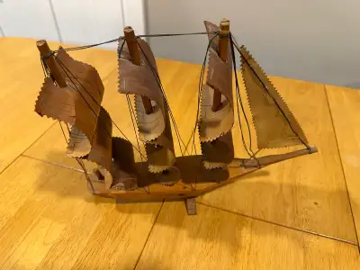 This is a used decorative wooden sailboat model, perfect for adding a nautical touch to any room. Th...