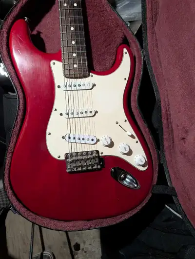 Beautiful Trans Red American made Highway One Strat with case. Excellent playing guitar with a beaut...
