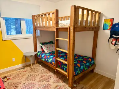 Solid wood bunk bed for sale in Redwood Meadows (mattresses not included). Selling because we’ve out...