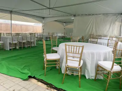 I'm offering various chairs, including gold Chiavari chairs with cushions, white folding chairs, and...