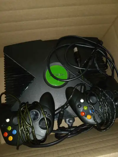 The orginal xbox with 2 controllers  and a bunch of games, View more