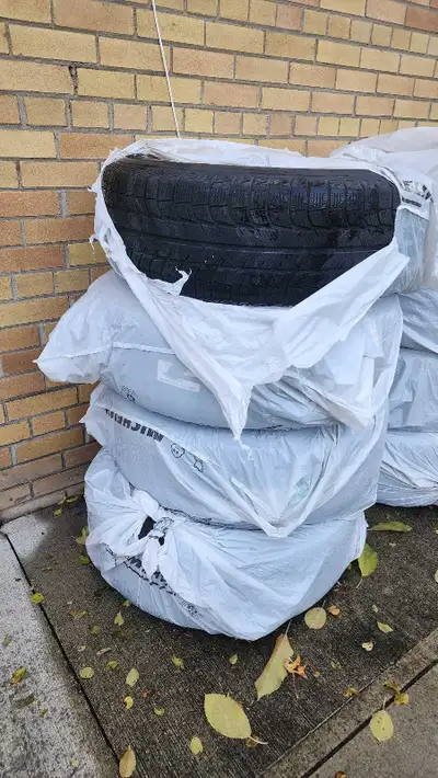 These are a set of Michelin winter tires, size 265/65R18, that came off a Cadillac Escalade. These t...