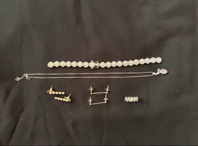 Flower tennis bracelet is broken but can be easily fixed by a jeweler. Includes a daisy flower ring...
