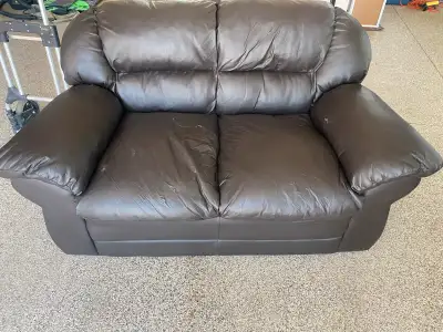 Brown faux leather loveseat damaged, View more