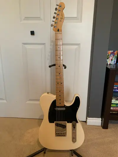 Fender MIM White Telecaster with Black Pickguard In very good condition two small chips, one on the...