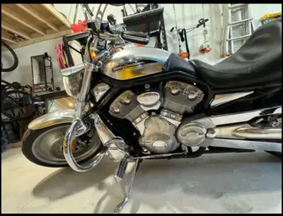 Roaring onto the scene is the iconic Harley Davidson V-Rod 2003, a true classic in excellent conditi...