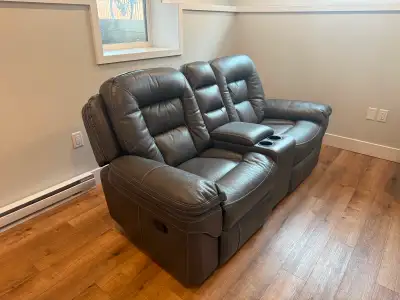 Leather reclining and rocking sofa., View more