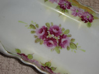 Antique rolled edged porcelain flat dish  with roses and  gold