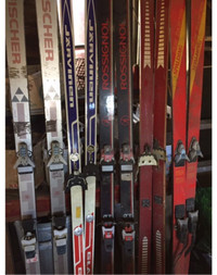 Lot of downhill and cross country skis