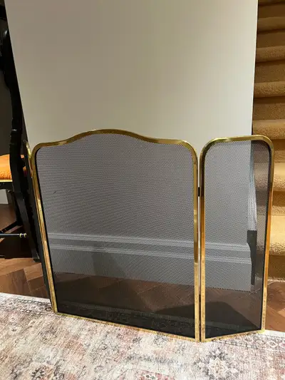 This is a 1970s brass and metal mesh triptych screen for protection fire spitting from the fireplace...