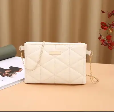 Elevate your style with this chic, quilted crossbody bag featuring a sleek gold chain strap and a co...