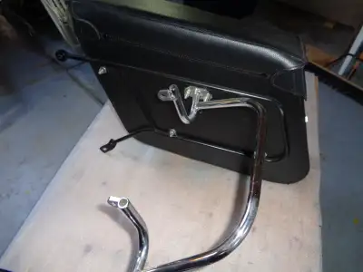 A set of Moto Guzzi Leather covered rigid nylon side cases, buckle closures, includes removable inne...