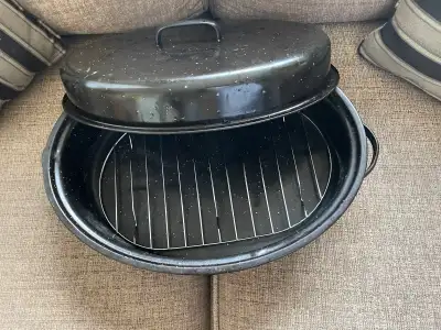 I am selling a used oval roasting pan with a lid and roasting rack, perfect for cooking a large roas...