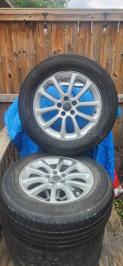 Four 235/65R18 all-season with four rims. Text only please 6137902121