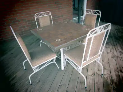 Outdoor table / chairs set. Cast iron / ceramic table top. Asking $100. Pick up in Cobourg