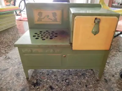 Children's metal ware electric stove from the 1920s and 1930s. Measures 8 inches wide, 6 inches tall...