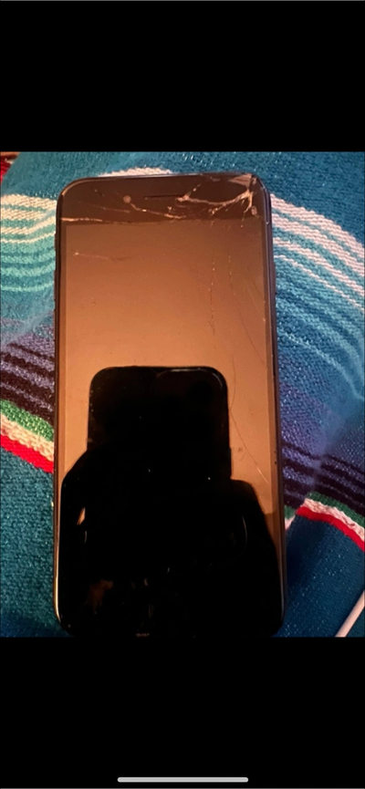 Damaged iPhone. Screen cracked. For parts or repair. Black.