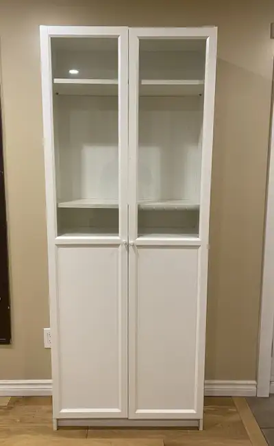 IKEA BILLY bookcase / Cabinet with OXBERG glass and panel doors in good condition. Features adjustab...