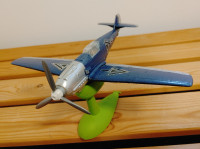 Miniature airplane with wind-up moving propeller