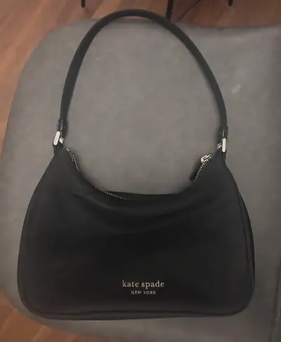 Kate Spade New York black nylon shoulder bag. It features a zippered main compartment and an interio...