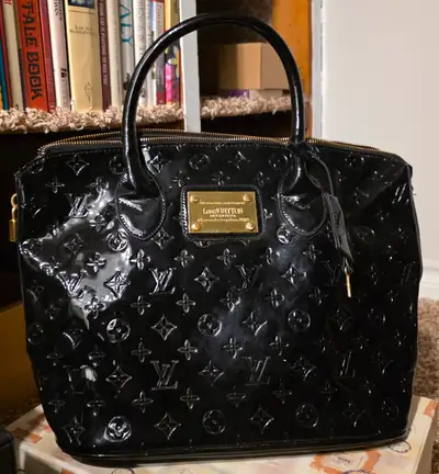 It is not real LV Black, embossed monogram and symbols, gold toned details