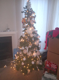Full Christmas tree set with fairy lights and white ornaments.