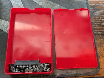 I'm selling a used red external hard drive enclosure. This enclosure supports SSD SATA drives and co...