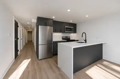 Modern Black Kitchen with Waterfall Island – Custom Cabinets, View more