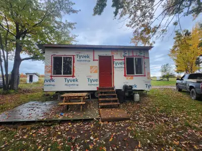 12x22 camp built on a trailer frame located on 1 arce wooded lot in minto nb with dirtroad access. T...