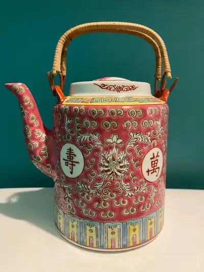 A Mun Shou porcelain flat lid teapot that holds 6 cups in the Famille Rose Longevity pattern and bam...