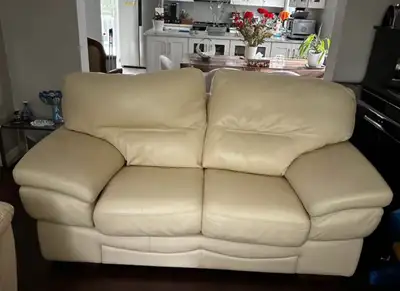 Cream-coloured leather two-seater sofa, in excellent condition. The seat cushions are removable and...