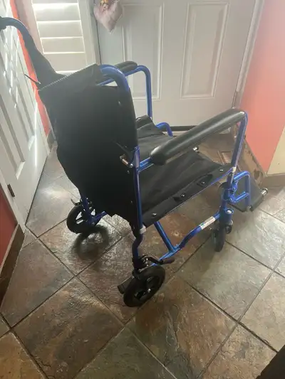 Portable wheel chair. Folds up for putting into a vehicle. Like new