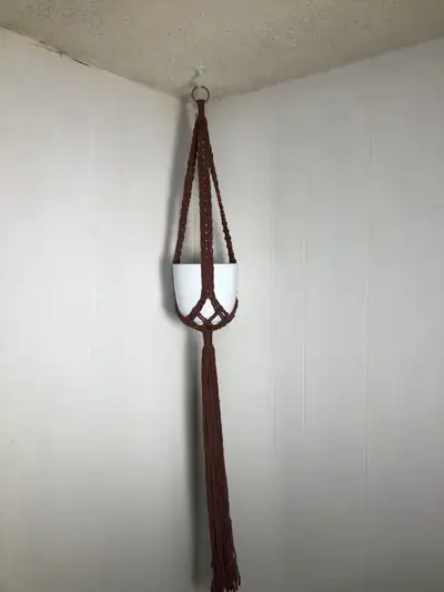 Brown Macrame Plant Hanger. NEW. 54” long Fits pots up to 8” maximum. Round bottom pots fit better....