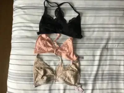 Beige is BODY by Victoria. Other two are bralette. Lightly lined with front closure. Size small. Bla...