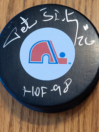 Autographed hockey puck by Peter Stastny