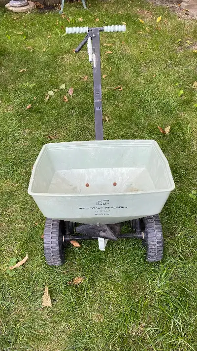 Fertilizer spreader for your lawn and garden maintenance . See attached photos .