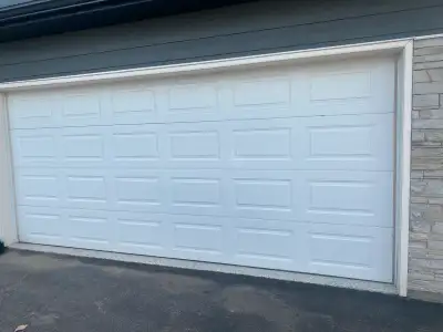 This is a used Calgary Garage Door, sized 16x7, available for $500. The door is in good condition an...